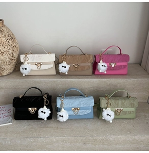 Chic pleated mini flap bags in various colors featuring metal locks and plush pendants