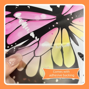 Detail of pink and yellow butterfly wall sticker showing easy-peel adhesive backing