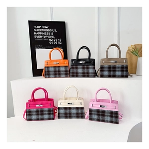 Detail of various vintage plaid tote bags with leather stitching and metal turn-locks