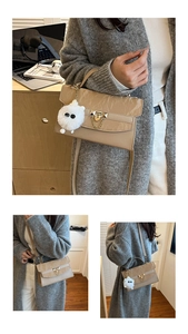 Detail of beige textured crossbody bag featuring gold chain buckle and plush monster charm