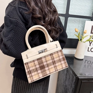 Chic 2025 vintage Kelly bag with beige leather, plaid fabric, and silver hardware clasp