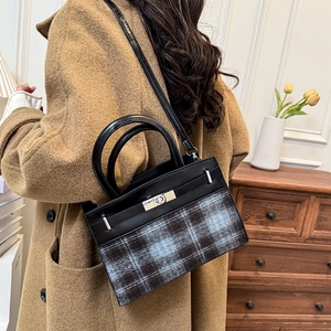 Fashion plaid handbag with metal lock shown in a stylish brown coat outfit