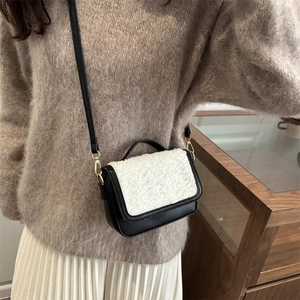 Chic black leather and white faux fur crossbody bag for women, perfect for autumn style