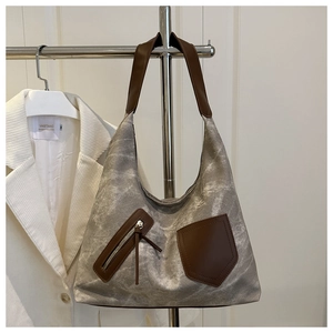 Detail of grey marble canvas tote bag with brown PU leather straps and zippered pocket