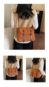 Detail view of a caramel matte leather messenger bag with silver buckles and retro straps