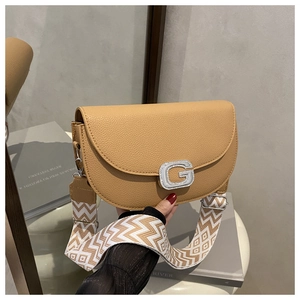 Detail of khaki saddle bag with crystal G buckle and patterned woven strap