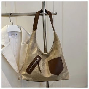 Detail of vintage canvas tote bag with brown leather straps and front zipper pocket