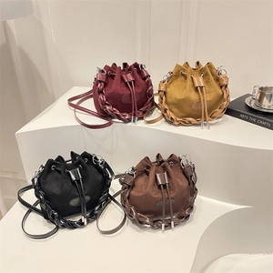Minimalist drawstring bucket bag in four vintage colors with woven leather trim