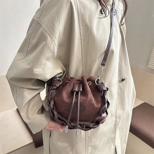 Retro dark brown frosted suede bucket bag with leather braiding and drawstring closure