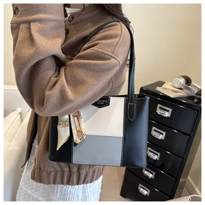 Close-up of tricolor tote bag with contrast stitching and vintage scarf wrapped handle