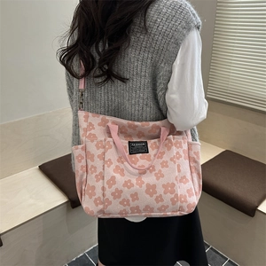 Pink floral canvas tote bag with top handles and fashion instinct label for daily use