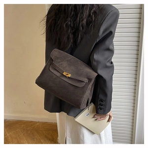 Detail of dark charcoal matte tote bag featuring gold metal buckle for commuting style