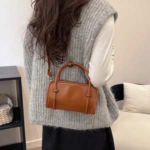 Retro caramel brown baguette bag with top handle and FASHION embossed logo lettering