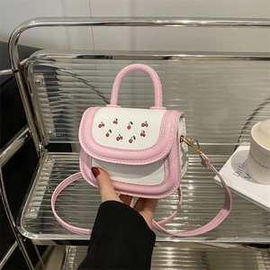 Pink and white leather mini handbag with cherry print and gold hardware crossbody strap