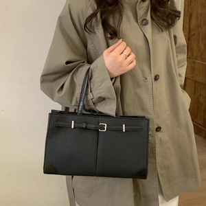 Minimalist black tote bag with textured faux leather and silver buckle for women
