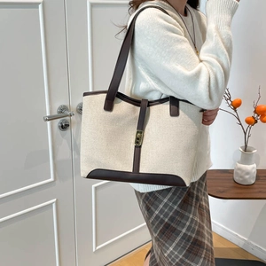 French vintage canvas tote bag with contrast leather trim and large capacity shown on shoulder