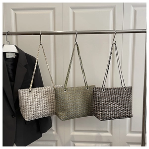 Three stylish tweed woven tote bags with metal chain straps in beige, green and black