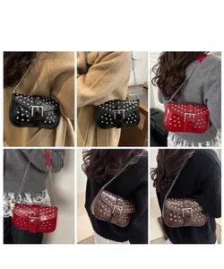 Detail view of punk style rivet chain bags in black red and brown worn by model