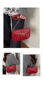 Detail of red punk shoulder bag with silver studs, chain strap and leather handle