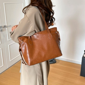 Brown tote bag with cartoon embossed pattern and long shoulder straps for women