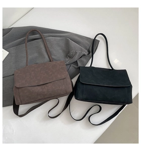 Detail view of simple matte leather shoulder bags in coffee and black colors