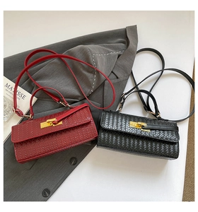 Detail showing woven texture and gold twist locks on burgundy and black flap bags