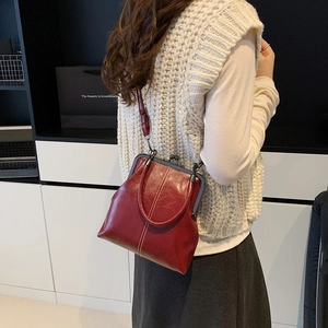 Vintage dark red doctor bag with contrast stitching and metal clasp for women