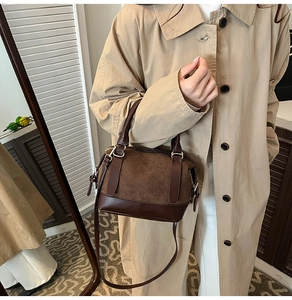 Detail of the brown suede and leather splicing texture on the vintage Boston bag