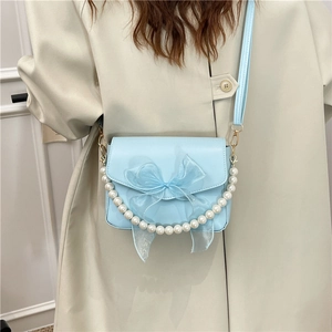 Light blue crossbody bag with mesh bow, pearl chain strap, and adjustable shoulder strap