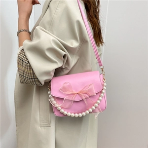 Chic pink leather crossbody bag with mesh bow and pearl chain strap for women