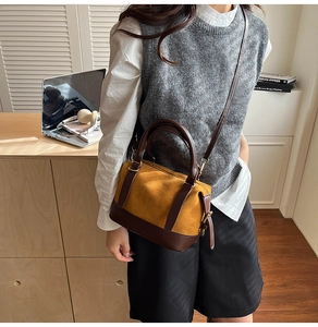 Brown leather and yellow suede Boston bag worn with grey knit vest and white shirt