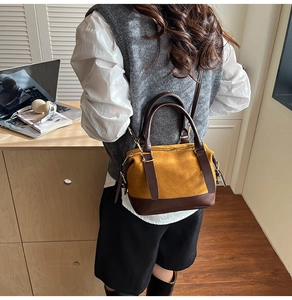 Detail showing vintage patchwork Boston bag in ginger suede and dark brown leather