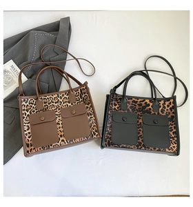 Detail of leopard print tote bags with front pockets and adjustable shoulder straps