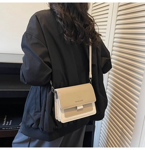 Detail of minimalist beige faux leather flap bag with Fashion & Bags logo engraving