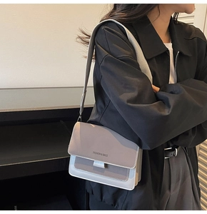 Modern minimalist crossbody bag featuring contrast colors and stylish wide shoulder strap