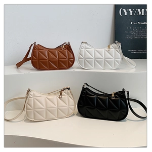 Close-up of four colors of quilted PU leather underarm bags with golden zippers