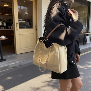 Beige oversized tote bag with gold chain, pearl charms and retro shoulder strap style