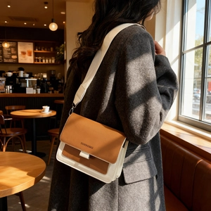 Chic two-tone brown and cream crossbody bag with wide strap for trendy urban women