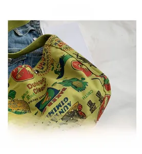 Close-up of vintage canvas shoulder bag featuring retro artistic graffiti and metal rivets