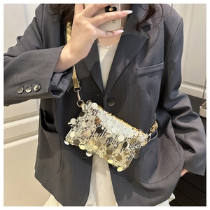 Mirror selfie showing a sequined shoulder bag with gold chain strap on grey blazer outfit