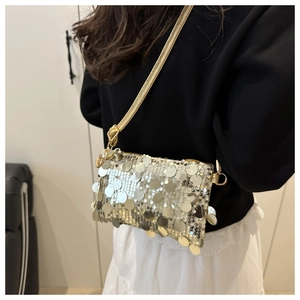 Detailed view of silver and gold sequin crossbody bag with a slim metal shoulder strap
