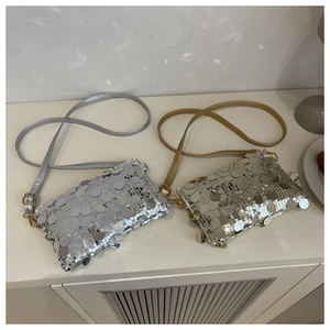 Detail view of silver and champagne sequin crossbody bags with metallic luster