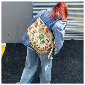 Detail of vintage graffiti canvas crossbody bag showing large capacity and adjustable strap