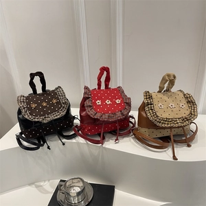 Floral polka dot mini backpacks in coffee, red, and caramel with ruffled flower details
