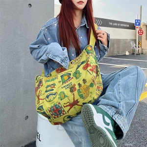 Vintage graffiti canvas shoulder bag in yellow with retro cartoon prints and wide strap