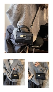 Detail of black pebbled leather handbag with gold twist lock and adjustable strap