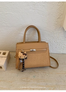 Detail view of a retro contrast leather handbag with Hello Kitty charm and silver lock