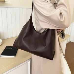 Minimalist large brown hobo tote bag shown on model for daily commuting style