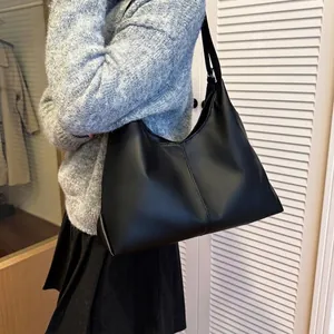 Minimalist black matte leather hobo bag with spacious interior for daily commute