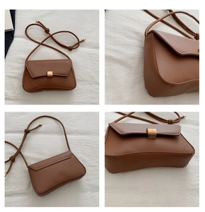Detail view of brown PU leather crossbody bag featuring a woven strap and metal buckle